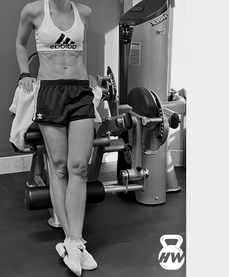 Black and white photo of a female client's toned legs and core after her training program